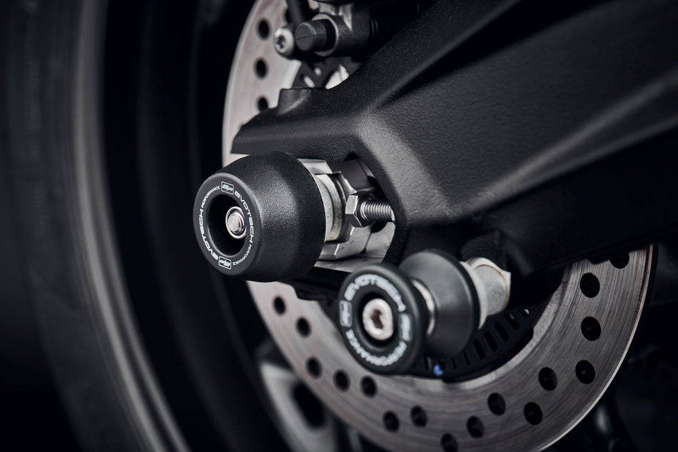 The rear wheel and swingarm of the Triumph Street Triple 765 RS with EP Rear Spindle Bobbins installed to offer Evotech Performances crash protection to the motorcycles rear end. 