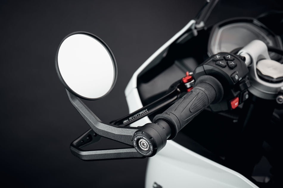 Evotech Bar End Mirrors / Brake and Clutch Protector Kit for the Triumph Daytona 660 attached to the handlebar ends of the motorcycle. EP's circular mirrors and integrated lever protector are installed using a bespoke fitting design.