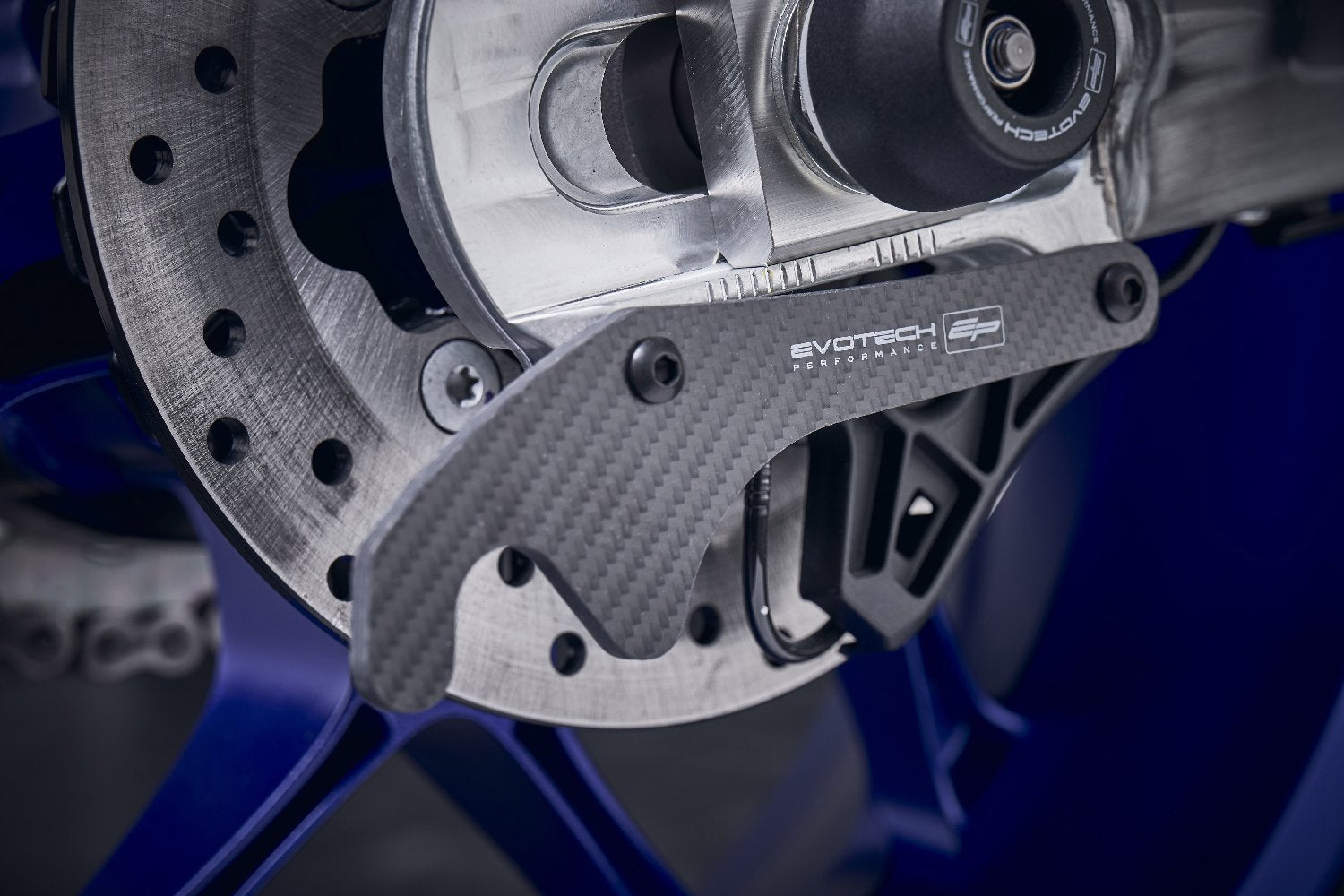 The rear swingarm of the Yamaha YZF-R1M with EP Carbon Fibre Paddock Stand Plates installed, ready to be attached to the paddock stand to elevate the rear wheel.