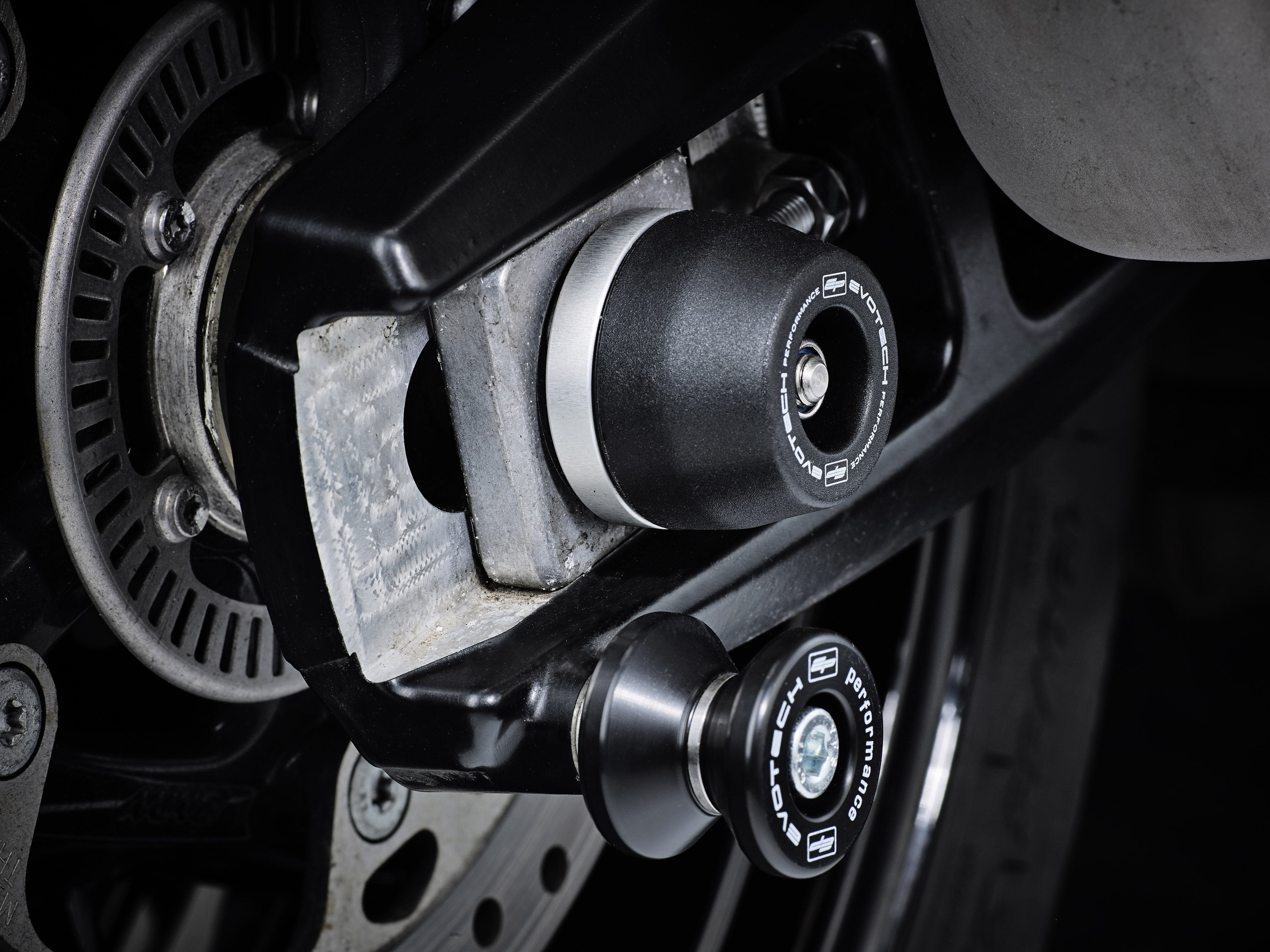 The offside rear wheel of the BMW S 1000 XR with EP Spindle Bobbin secured to the swingarm and near EP Paddock Stand Bobbins.