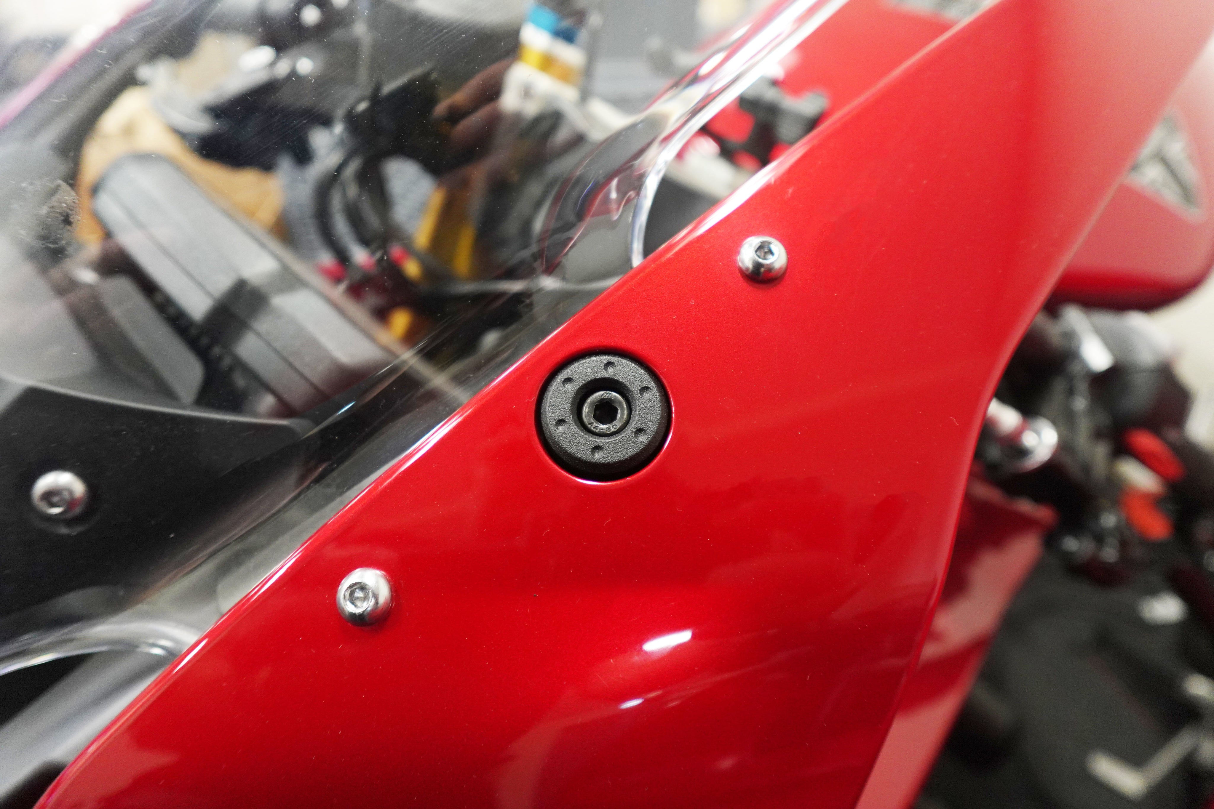 Evotech Mirror Blanking Plates inserted into the front fairing of the motorcycle to plug the original mirror mounting point.