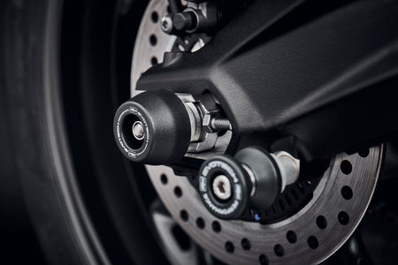 The rear wheel and swingarm of the Triumph Street Triple RS with EP Rear Spindle Bobbins installed to give Evotech Performanceâs crash protection to the motorcycleâs rear end. 