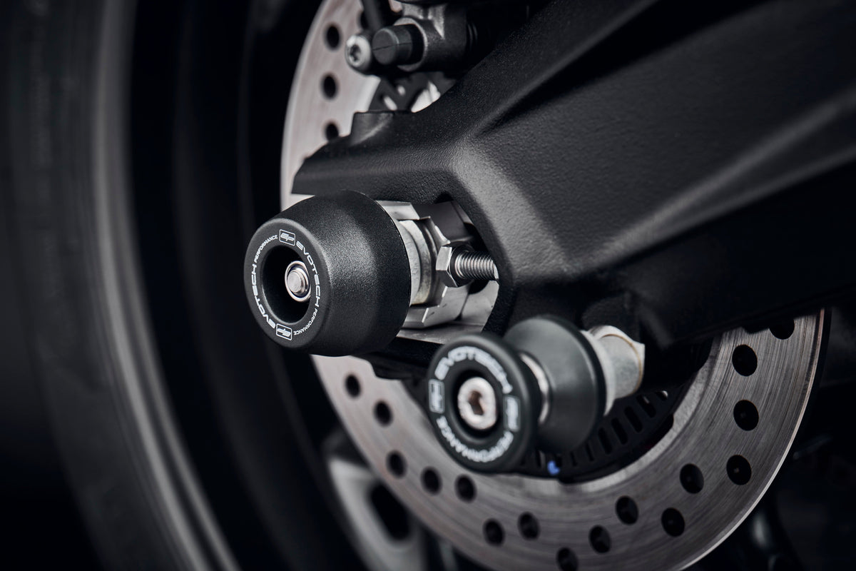 The rear wheel and swingarm of the Triumph Street Triple 765 Moto2 Edition with EP Rear Spindle Bobbins installed to offer Evotech Performances crash protection to the motorcycles rear end. 