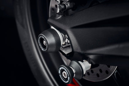 Evotech Performanceâs signature spindle bobbin crash protection installed to protect the rear wheel and swingarm of the Triumph Street Triple RS.