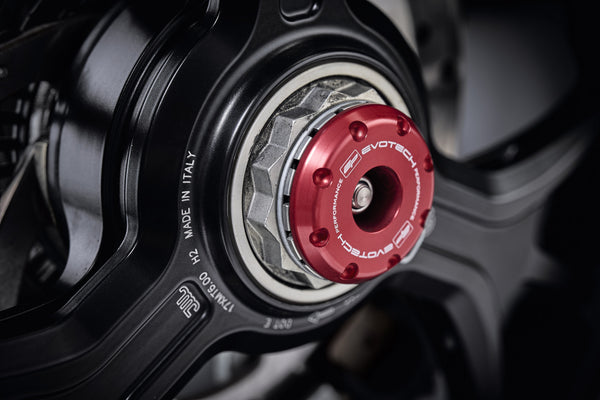 The striking anodised red hub stop from the EP Spindle Bobbins Crash Protection Kit fitted to the offside rear wheel of the Ducati Multistrada V4 Pikes Peak.