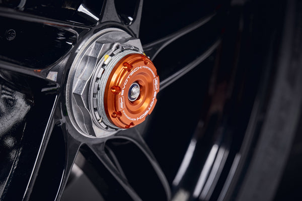 The exhaust side wheel of the KTM 1290 Super Duke R Evo fitted with the anodised orange hub stop of EP Rear Spindle Bobbins crash protection.