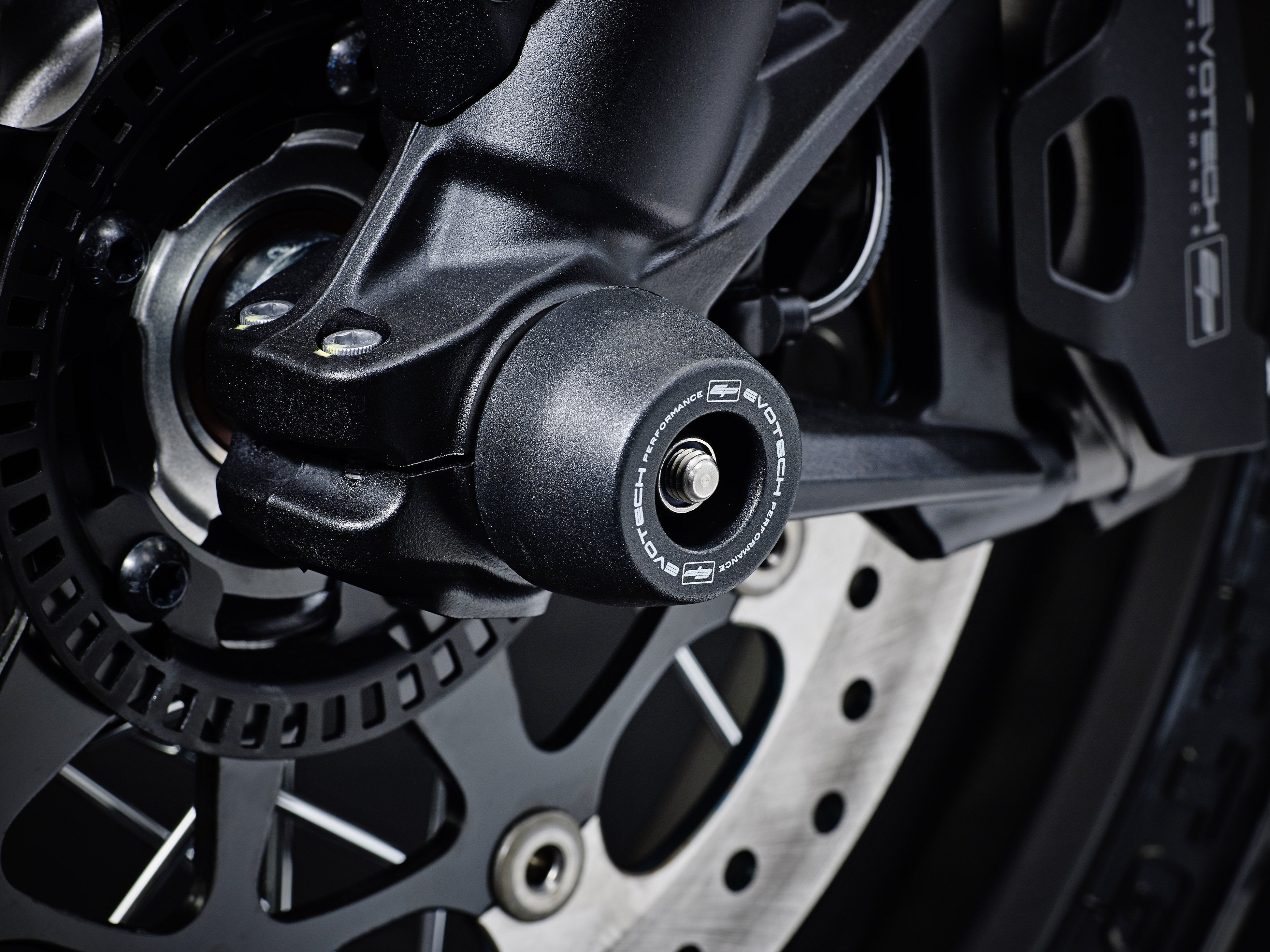 EP Spindle Bobbins Crash Protection Kit fitted to the front wheel of the Ducati Scrambler Icon Dark, guarding the front forks and brake calipers.
