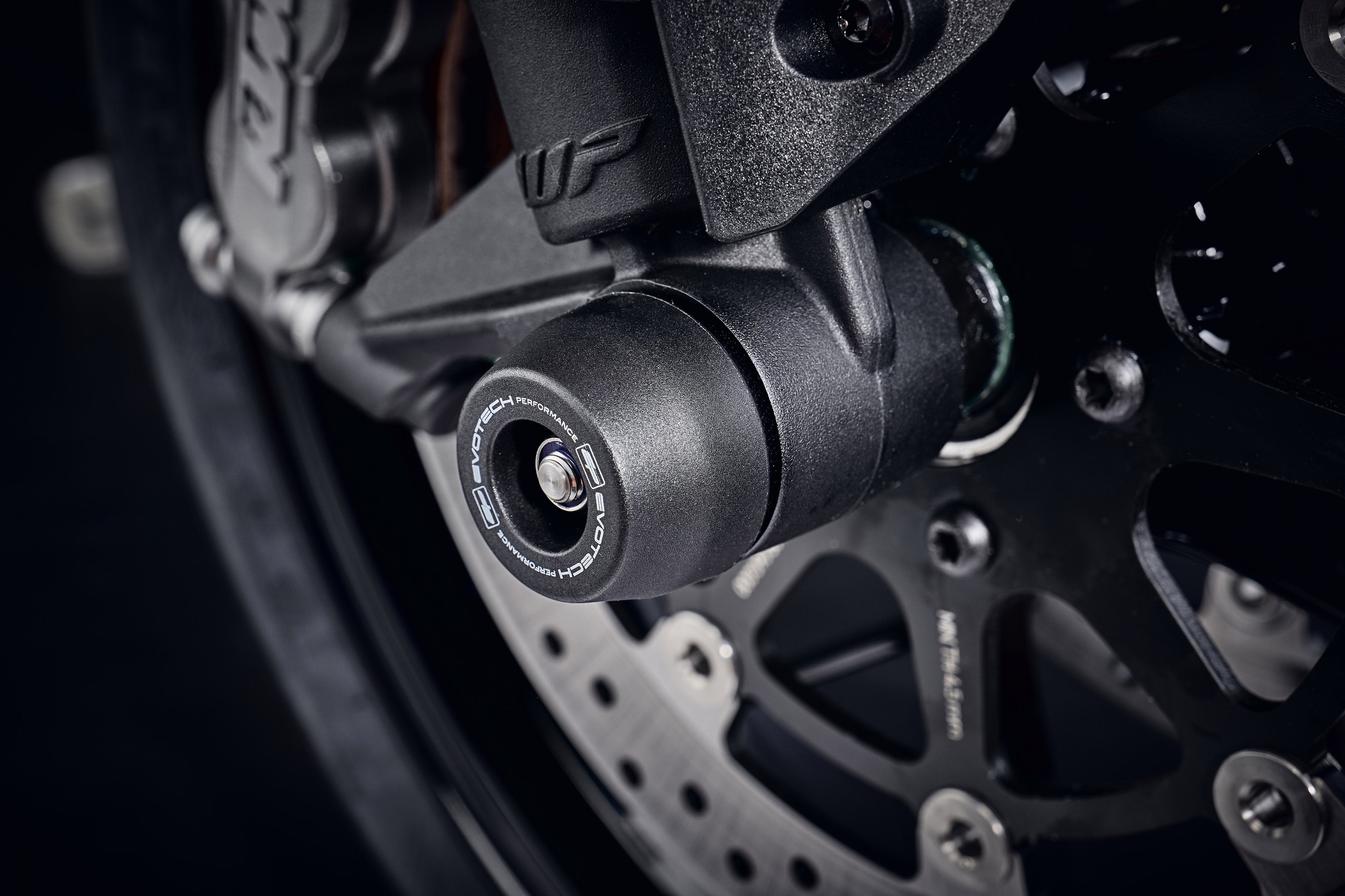 The injection-moulded nylon crash bung of EP Front Spindle Bobbins installed onto the front wheel of the KTM 890 Duke R, giving strong crash protection to the front forks and brake calipers.